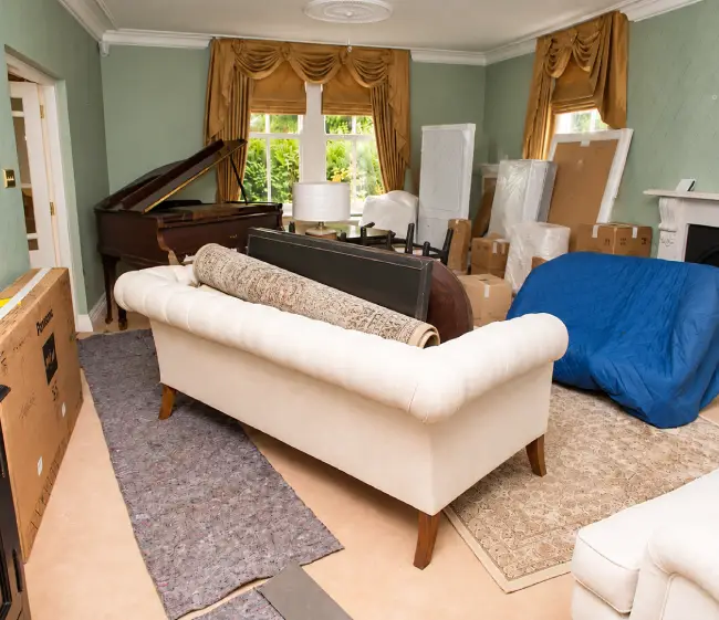 Living room packed with furniture and boxes awaiting a full cleanout