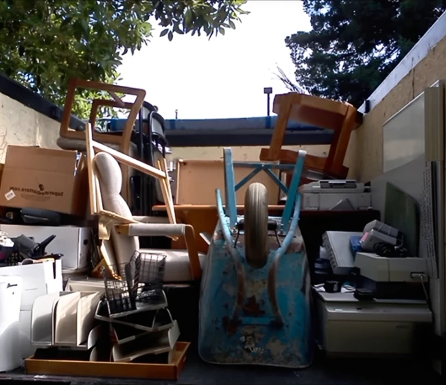 Truck bed fully loaded with furniture and junk hauled away by Best Valley Junk Removal
